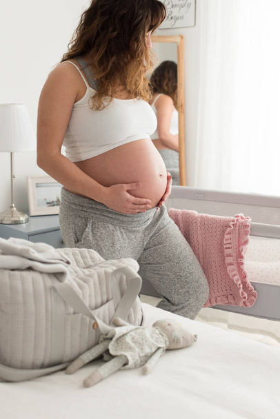 Pregnant woman touching her belly - Φωτογραφία, εικόνα