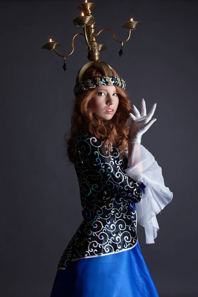 Beautiful dancer with candelabra on her head - Фото, изображение