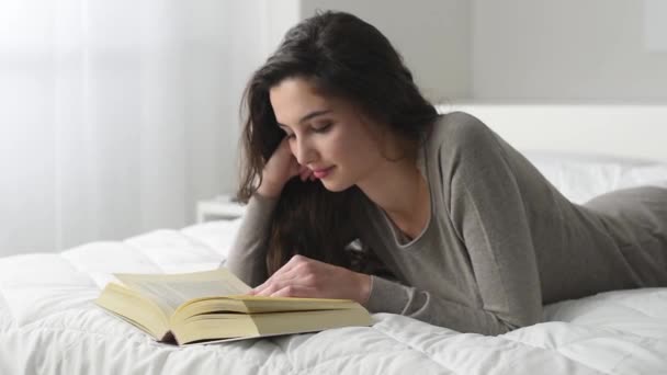 Γυναίκα ανάγνωση στο κρεβάτι - Πλάνα, βίντεο