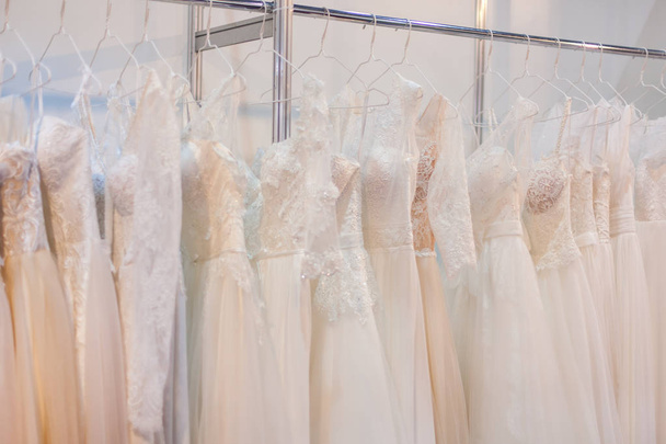 Rack with many beautiful wedding dresses. - Foto, Imagem