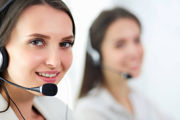 Smiling businesswoman or helpline operator with headset and computer at office - Foto, Imagem