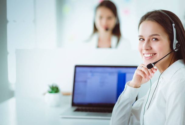 Smiling businesswoman or helpline operator with headset and computer at office - Φωτογραφία, εικόνα