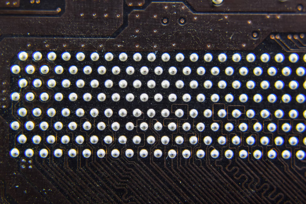 The reverse side of the microboard. Contacts solder. Soldered parts. Electronic board with electrical components. Electronics of computer equipment - Foto, afbeelding