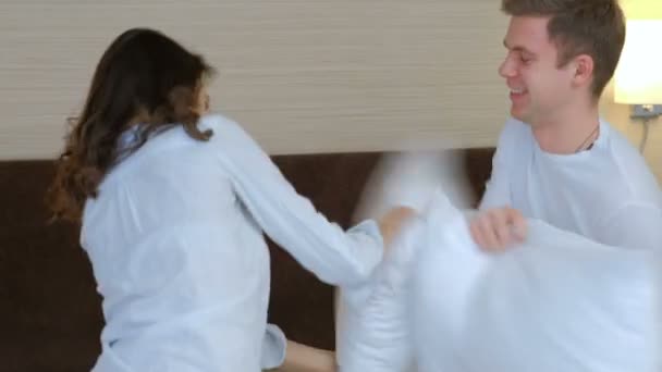 couple pillow fight hug joy leisure love emotion - Materiał filmowy, wideo