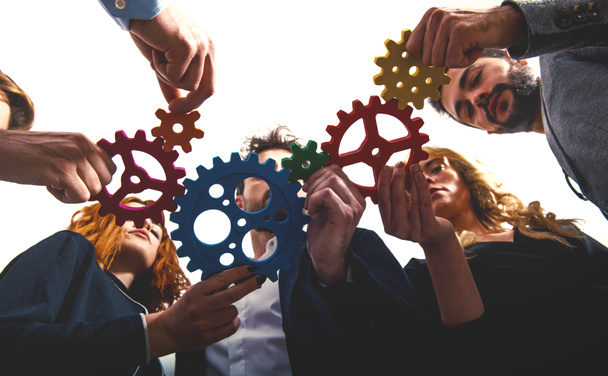 Business team connect pieces of gears. Teamwork, partnership and integration concept - Photo, Image