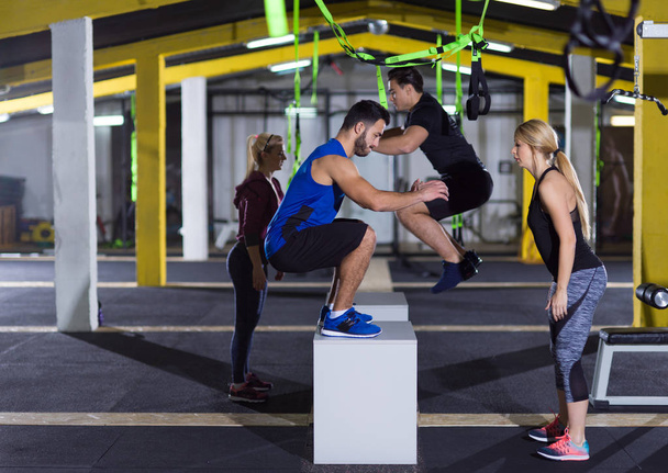 athletes working out  jumping on fit box - Zdjęcie, obraz