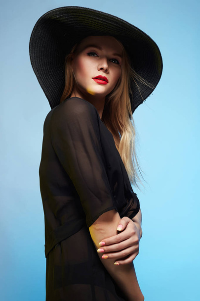 Beautiful young woman in hat - Фото, изображение
