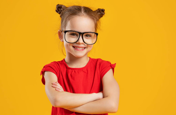 funny child girl in glasses on colored background   - Фото, изображение