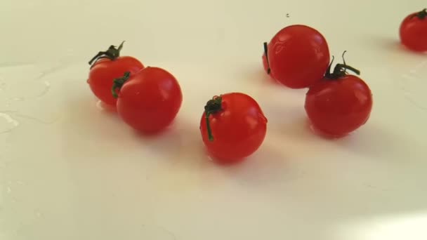 cherry tomatoes wet on white background, slow motion - Footage, Video