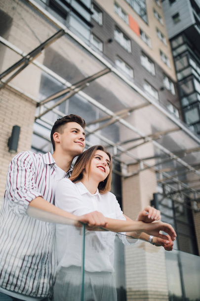 Happy couple in love on the front of modern buildings background. - Foto, Imagem
