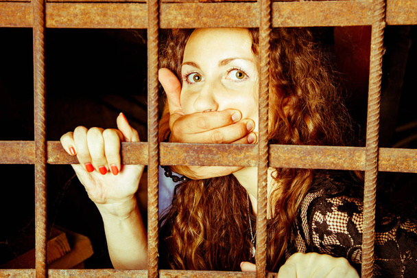 Woman hostage behind bars - Photo, Image