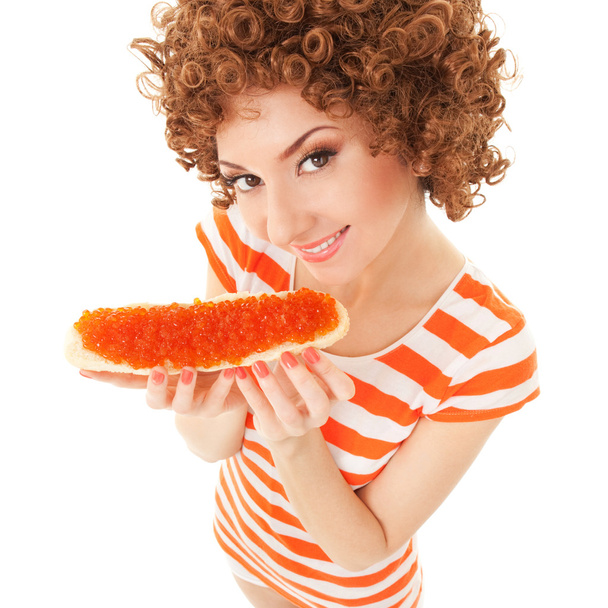 fun woman eating the sandwich with red caviar on the white backg - Foto, imagen