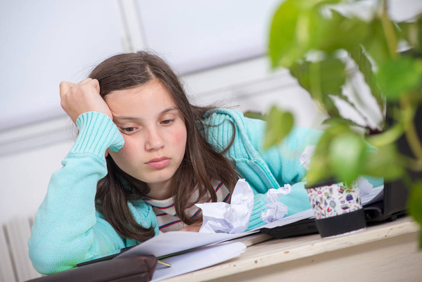 znudzony Nastoletni Dziewczyna jest odrabianie pracy domowej - Zdjęcie, obraz
