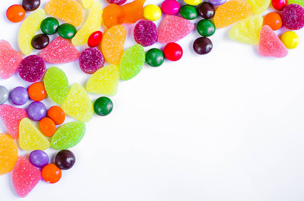 Scattered colored candy on a limited  - Photo, Image