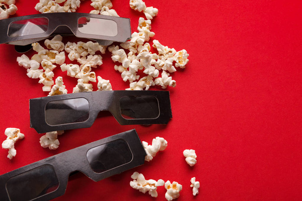 3D glasses and popcorn on red background - Photo, Image