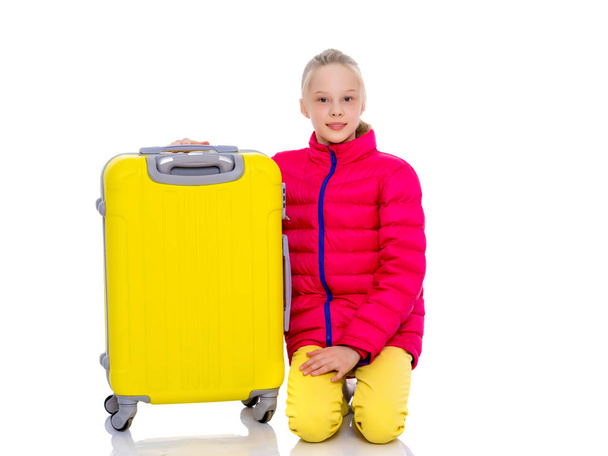 The girl gymnast with a large suitcase goes to the competition. - Zdjęcie, obraz