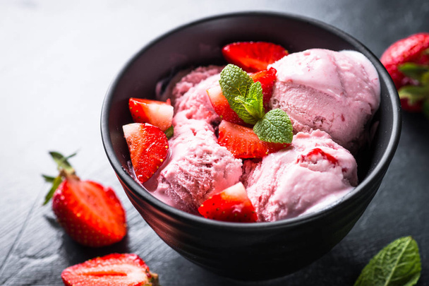 Strawberry ice cream with fresh berries on black.  - Photo, Image