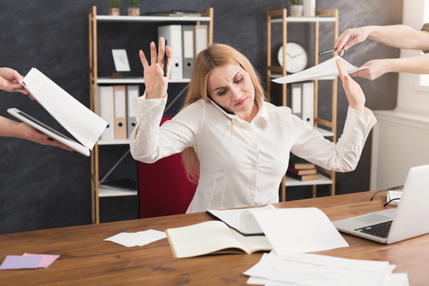 Busy woman in office gesturing stop to assistants - Photo, Image