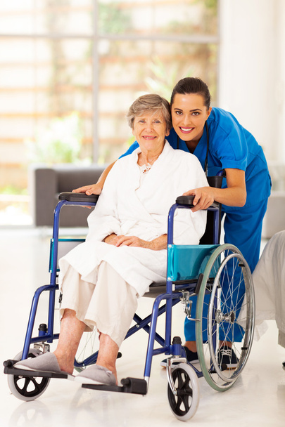 Elderly woman and young caregiver at home - Foto, Imagem