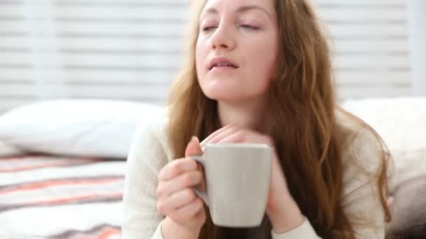 woman drinks coffee in bed bedroom - Video