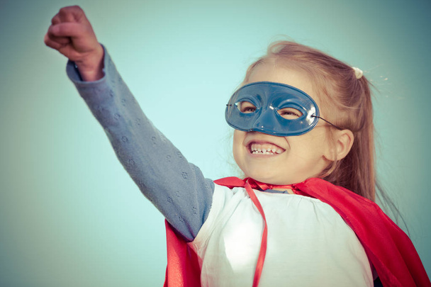 Funny little girl playing power super hero. - Фото, изображение