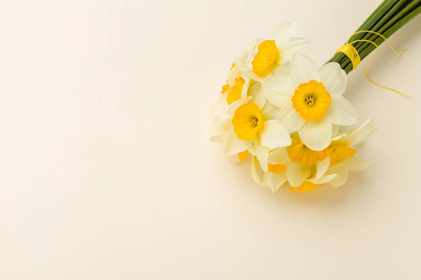 White daffodil bouquet on yellow pastel background with copy space. - Photo, Image