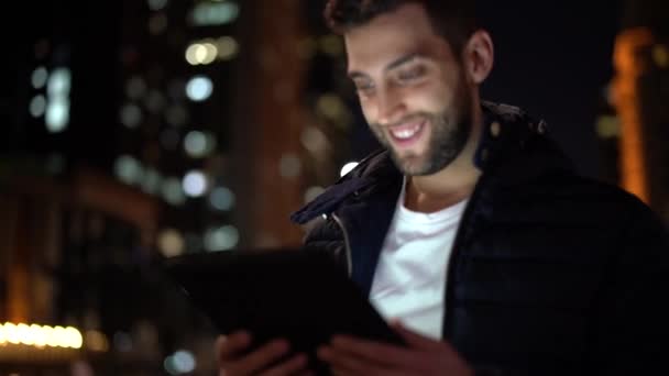 Portrait of a Guy using tablet at night - Záběry, video
