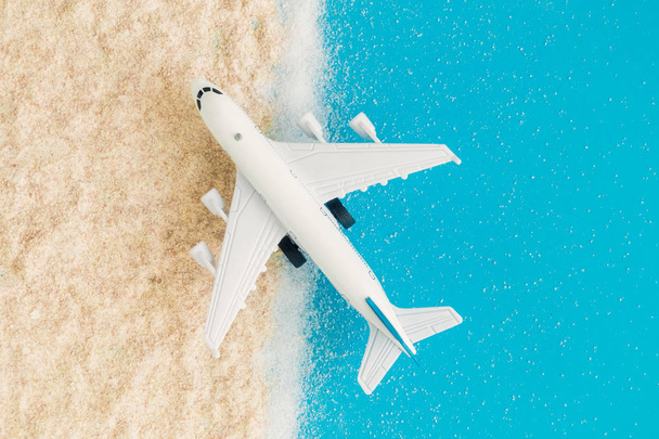 Flat lay of airplane on the beach abstract summer vacation travel concept. - Φωτογραφία, εικόνα