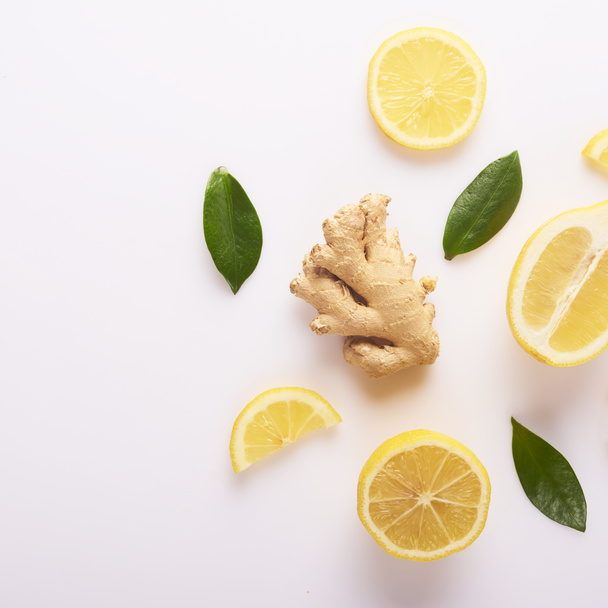 Fresh yellow lemons and ginger root isolated on white background - Фото, изображение