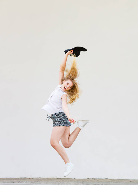 Woman in summer clothes jumping with sun hat - Fotoğraf, Görsel