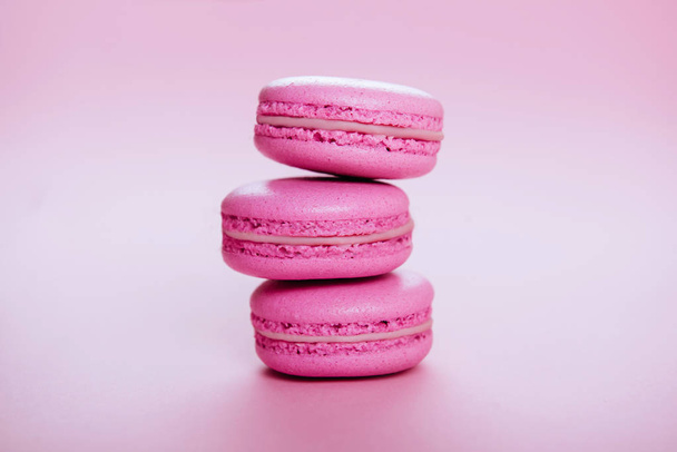 pink macaroons on pink background. - Фото, изображение
