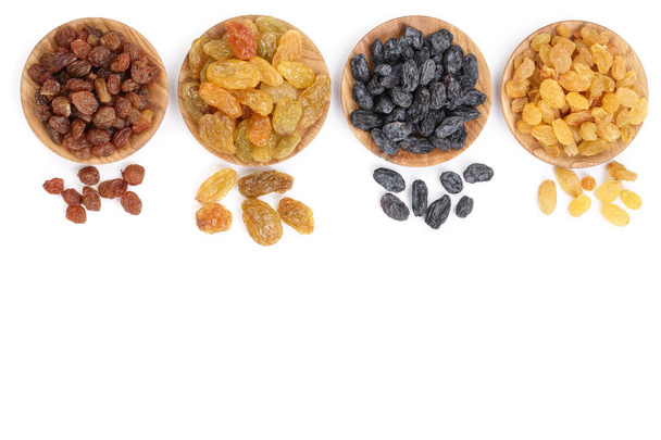 Collection of raisins in wooden bowl isolated on a white background with copy space for your text. Top view. Flat lay - Valokuva, kuva