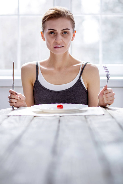 Nice pale woman holding a fork and knife - Fotoğraf, Görsel