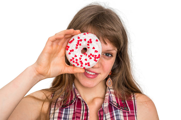 Attractive woman is holding donut against her eyes - 写真・画像