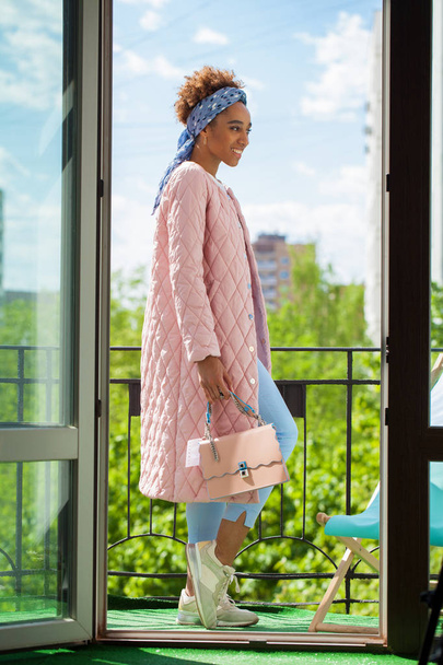 African model woman in pink spring jacket and blue pants - Fotoğraf, Görsel