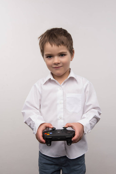 Joyful happy boy playing video games - Foto, afbeelding