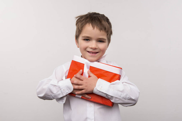 Cute small boy hugging a present - Fotó, kép