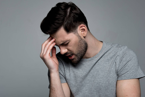 Youthful man is having deep pain in his head - Photo, image