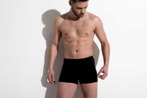 Attractive muscular guy is posing in underwear - Foto, imagen