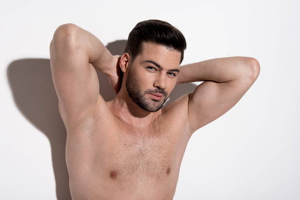 Attractive young man is enjoying his muscular body - Fotografie, Obrázek