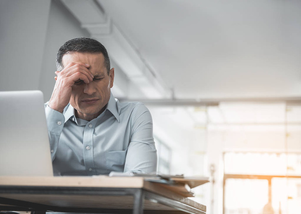 Worried businessman feeling headache at job - Φωτογραφία, εικόνα