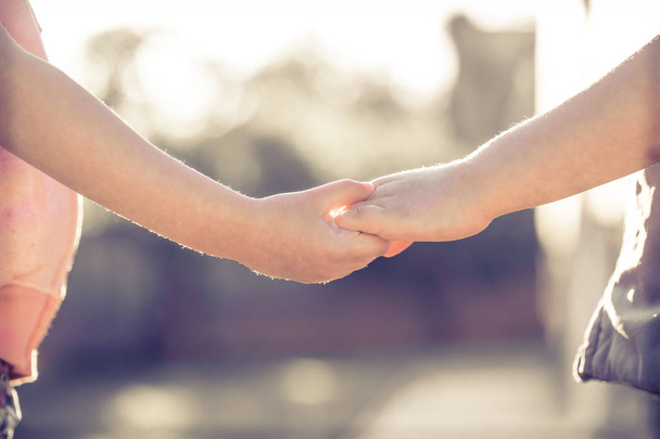 little girl and boy hold hands close-up, against the backdrop of - Photo, Image