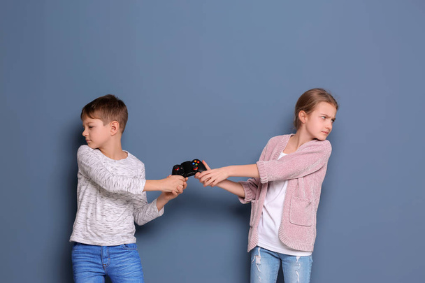 Brother arguing with sister on color background - Photo, image