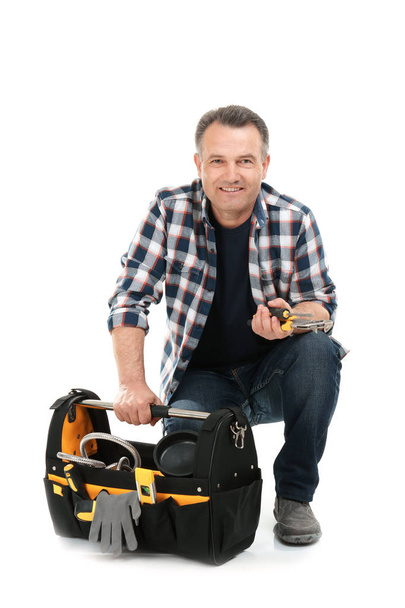 Mature plumber with tool bag on white background - Photo, image
