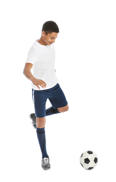 Teenage African-American boy playing football on white background - Foto, immagini