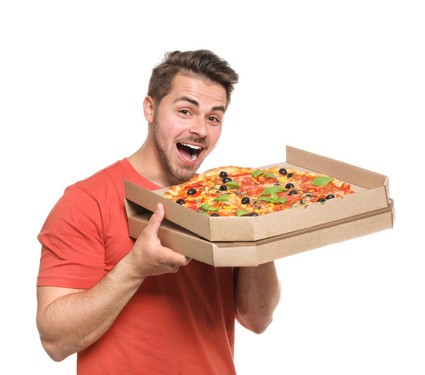 Attractive young man with delicious pizza on white background - Φωτογραφία, εικόνα