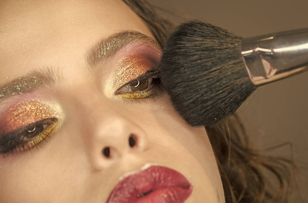 Beautiful woman applying foundation powder with makeup brush. - Φωτογραφία, εικόνα