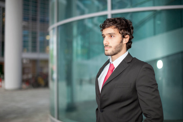 Handsome businessman in front of his office - 写真・画像