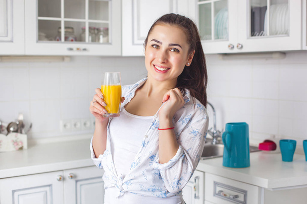Close up portrait of young attractive woman drinking fresh juice - Fotó, kép