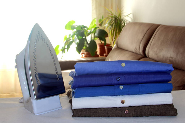 ironed shirts on dry cleaning hanger - Фото, зображення